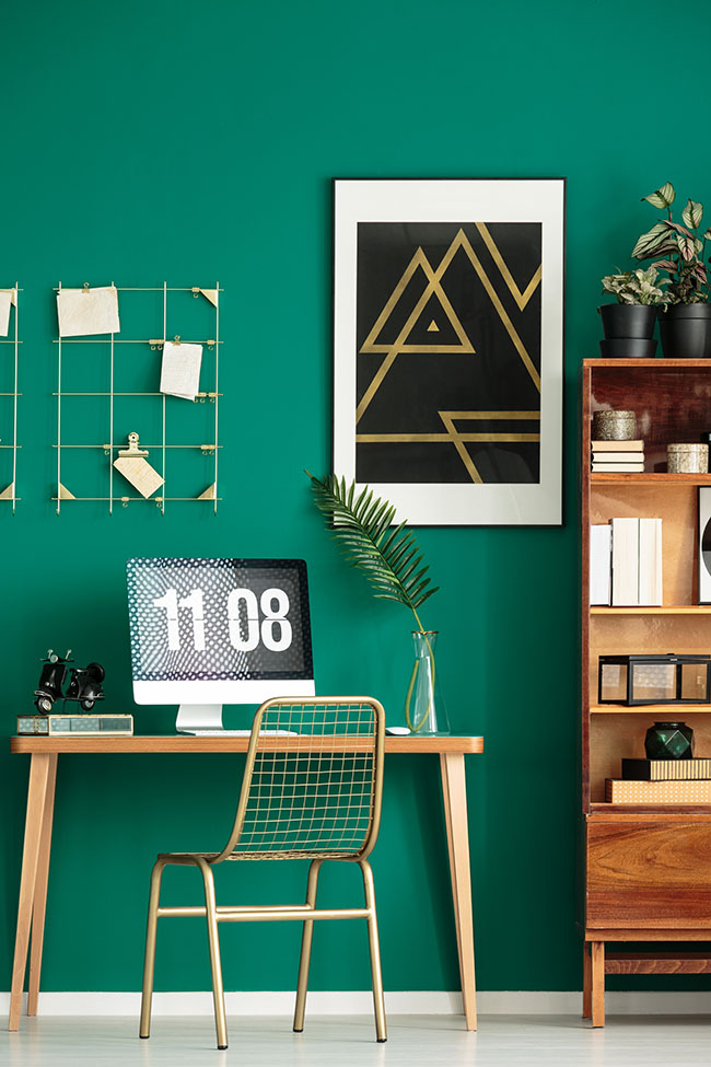 Interior painting with a bold green accent wall in a modern office.